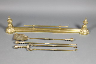 A brass fire curb 46" together with a 3 piece brass fireside companion set with shovel, poker and tongs