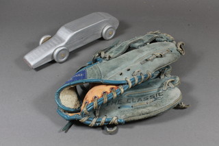 A silver painted wooden model of a motor car 9.5" and a blue  leather Spaldings The Classic baseball glove