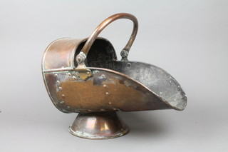 A copper helmet shaped coal scuttle 