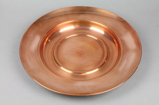 A circular polished copper charger 16" 