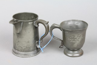 A 19th Century pewter half pint tankard with numerous touch marks and a Victorian pewter spouted pint measure