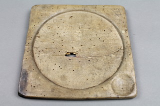 A 17th/18th Century square turned wooden plate 7 1/2" x 7", wormed and with hole