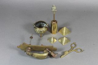 A pair of brass candle snuffers, a brass miniature cauldron 2", a door knocker etc
