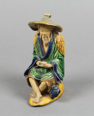 A Chinese figure of a seated fisherman 6in.

