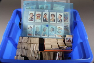A blue crate containing a quantity of loose cigarette cards