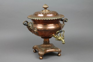 A Georgian copper and brass tea urn complete with lid, raised on bun feet 16"