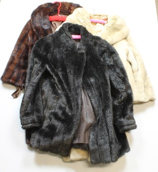 A brown fur coat and a black simulated fur coat 
