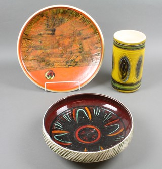 A 1960's Poole Pottery charger decorated in stylised orange motifs 15", a ditto shallow bowl 12", a yellow vase 9"
