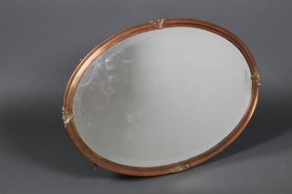 An Art Deco copper framed oval mirror