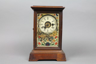 A 19th Century American alarm mantel clock with 4" metal dial and Roman numerals contained in a walnut case