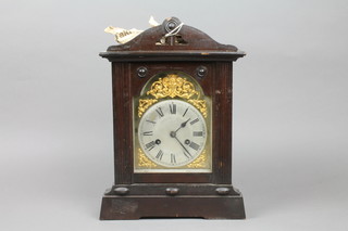 A 19th Century striking mantel clock with 6" heart shaped dial contained in a mahogany case 
