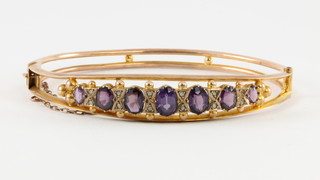 A 9ct gold amethyst and diamond set open bangle, gross 8.6grams