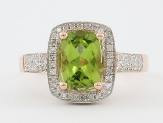 A 14ct rose gold cushion set peridot ring, approx 3.20ct, surrounded by brilliant diamonds, approx. 0.75ct
