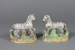 A pair of 19th Century Staffordshire figures of Zebra, f, 
