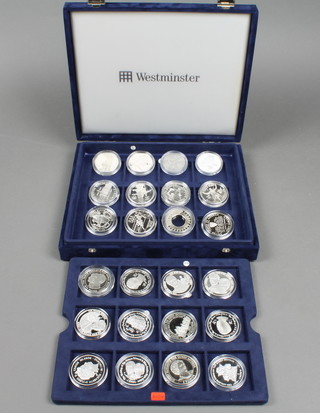 A boxed set of 24 silver commemorative crowns