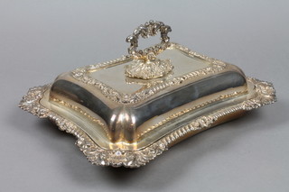 A plated entree dish and cover with scroll handle