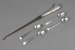 A repousse silver button hook together with 4 silver spoons