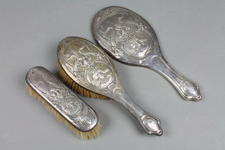 An Art Nouveau silver backed brush set with stylised flowers and portrait panels Chester 1902