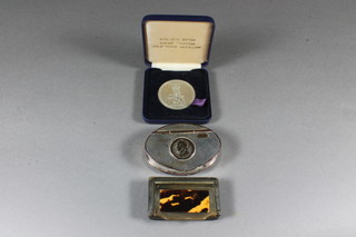 A rectangular horn snuff box 2.5", an oval silver plated snuff box 3" and a Cunard Countess medallion
