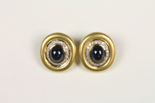 A pair of 18ct gold oval diamond and cabouchon cut sapphire ear clips, approx 1.2ct diamond