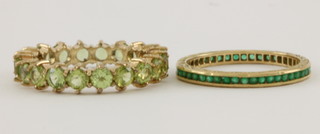 A gold emerald eternity ring and a do. 9ct gold peridot ring 