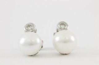 A pair of 18ct white gold pearl and diamond ear studs, approx 0.4ct