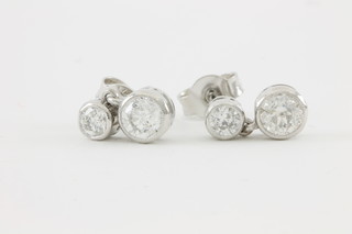 A pair of 18ct white gold 2 stone diamond drop ear earrings, approx 1.05ct