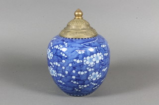 A ginger jar and cover decorated prunus, the base with 4  character mark and an associated gilt metal lid 6.5"
