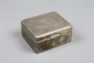A silver cigarette box with engine turned decoration and hinged lid, Birmingham 1921 4" 