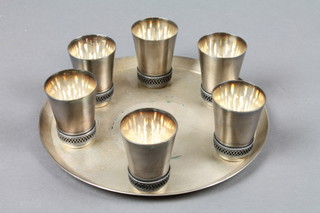 A Soviet Russian 7 piece silver plated vodka set comprising 7.5" circular salver and 6 shot glasses, marked 910mme
