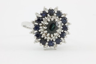 An 18ct white gold diamond sapphire cluster ring