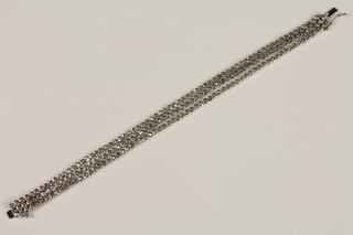 A Continental diamond set 3 strand silver bracelet