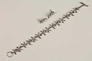 A Continental silver diamond set floral bracelet together with ensuite ear studs