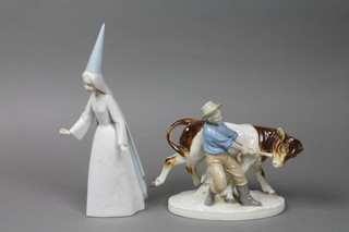 A Continental figure of a farmer and bull 9", a Lladro figure of a lady 10" (f)
