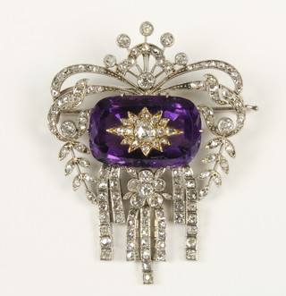 A fine Victorian amethyst and diamond open pendant brooch with scroll borders and articulated drops, centre stepped with a diamond inlaid amethyst, contained in a fitted case