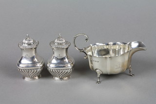A pair of Victorian silver baluster peppers, Chester 1900, a silver sauce boat Sheffield 1928, approx 6 1/2 ozs