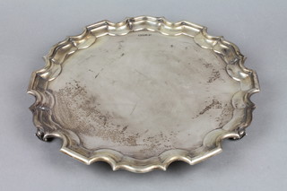 An Edwardian silver salver with Chippendale rim on acanthus scroll feet Chester 1908, 28 ozs, 13" diam.