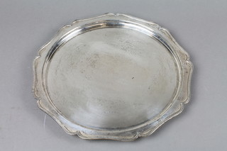 A silver salver with beaded rim on scroll feet, Birmingham 1928, 13", 24 ozs 