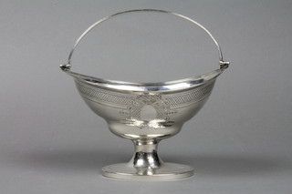 A Georgian silver elliptical swing handled sugar bowl with chased decoration and monogrammed cartouche, on a waisted base, London 1799, approx. 8 ozs