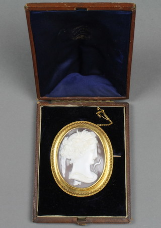A Victorian silver gilt cameo brooch with etruscan style mount, carved with a figure of a lady, f, 3", contained in a fitted case. Shell cracked.