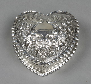 A Victorian repousse silver heart shaped dish decorated with scrolls, birds and fruit, London 1888, 4"