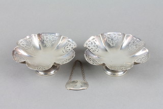 A pair of silver tazza with pierced decoration on waisted stems, Sheffield 1958 and a spirit label