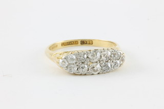 An 18ct gold and platinum 12 stone diamond half hoop ring