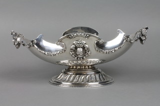 A Spanish silver boat shaped fruit bowl with fruit and flower handles and portrait medallions, on a fluted base, approx 33 ozs