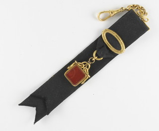 A Victorian rolled gold and black silk watch chain fob hung a double sided seal