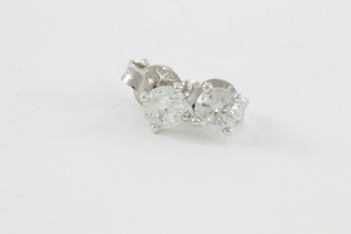 An 18ct white gold single stone diamond ear studs, approx 0.71ct