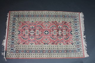 A red ground Afghan rug with 12 octagons to the centre 70" x 40"