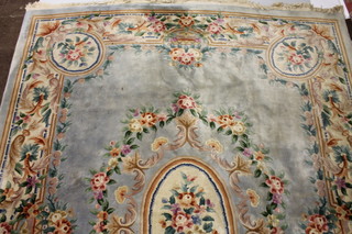 A blue ground and floral patterned Chinese carpet with central medallion, some staining 103" x 101"