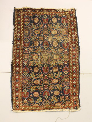 A blue ground Caucasian rug, worn, 45" x 28"