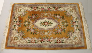A yellow ground and floral patterned Chinese rug 73" x 48"